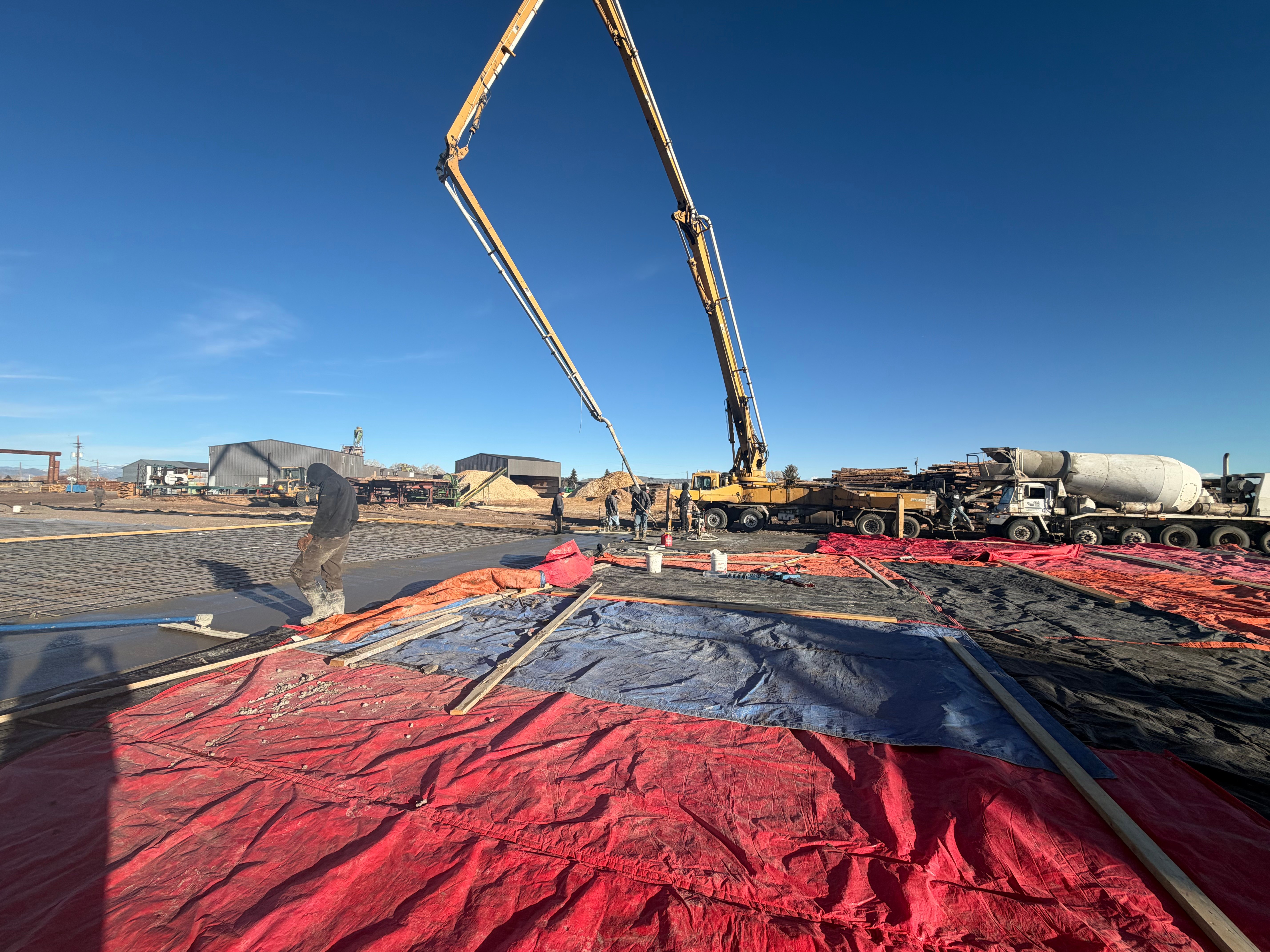 Commercial concrete pour with pump truck at an industrial site in the San Luis Valley